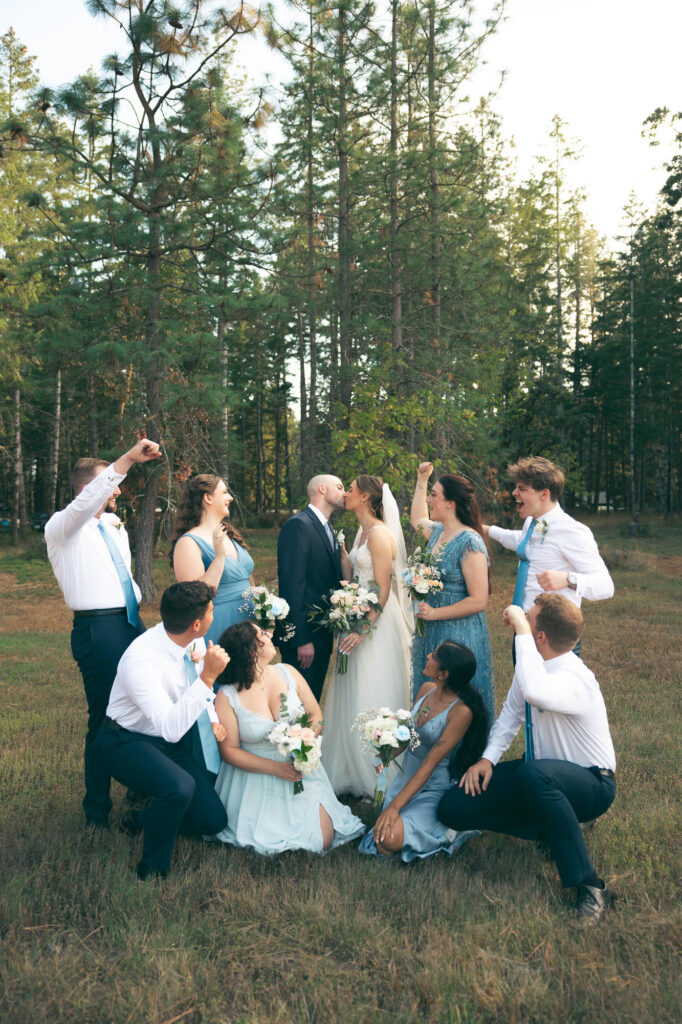 bridal party photo of everyone cheering for the bride and groom