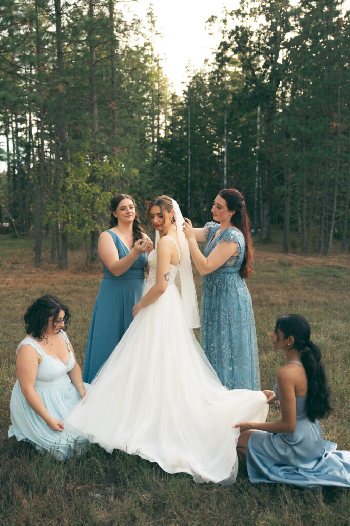 bridesmaids helping bride get ready to get married