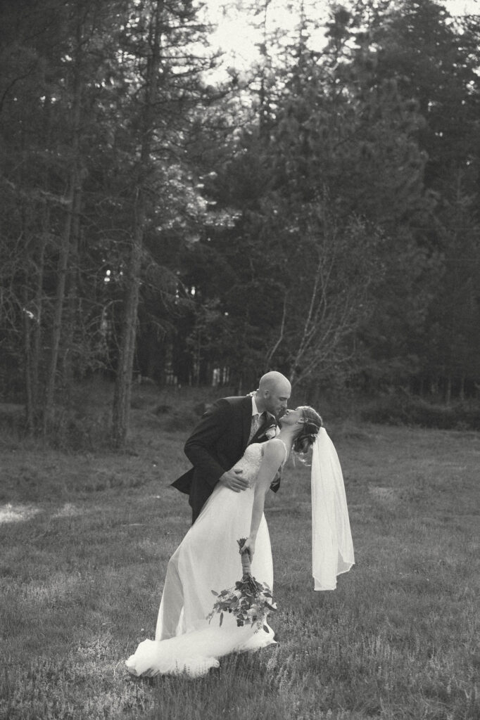 groom dipping his bride in oregon