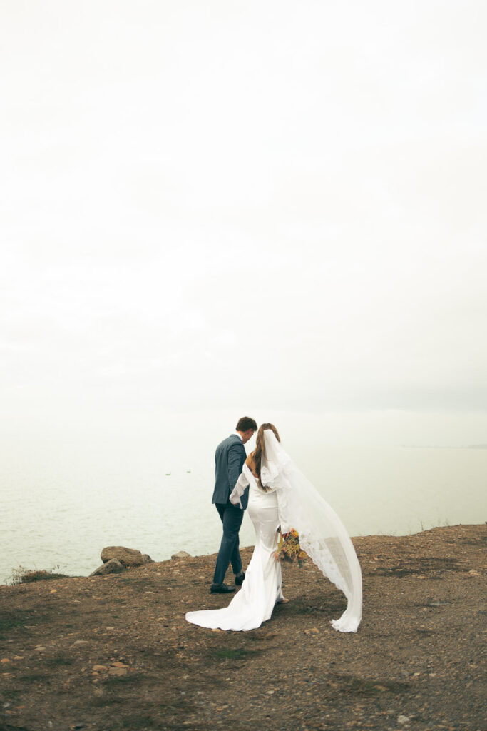 documentary photo of bride and groom walking away