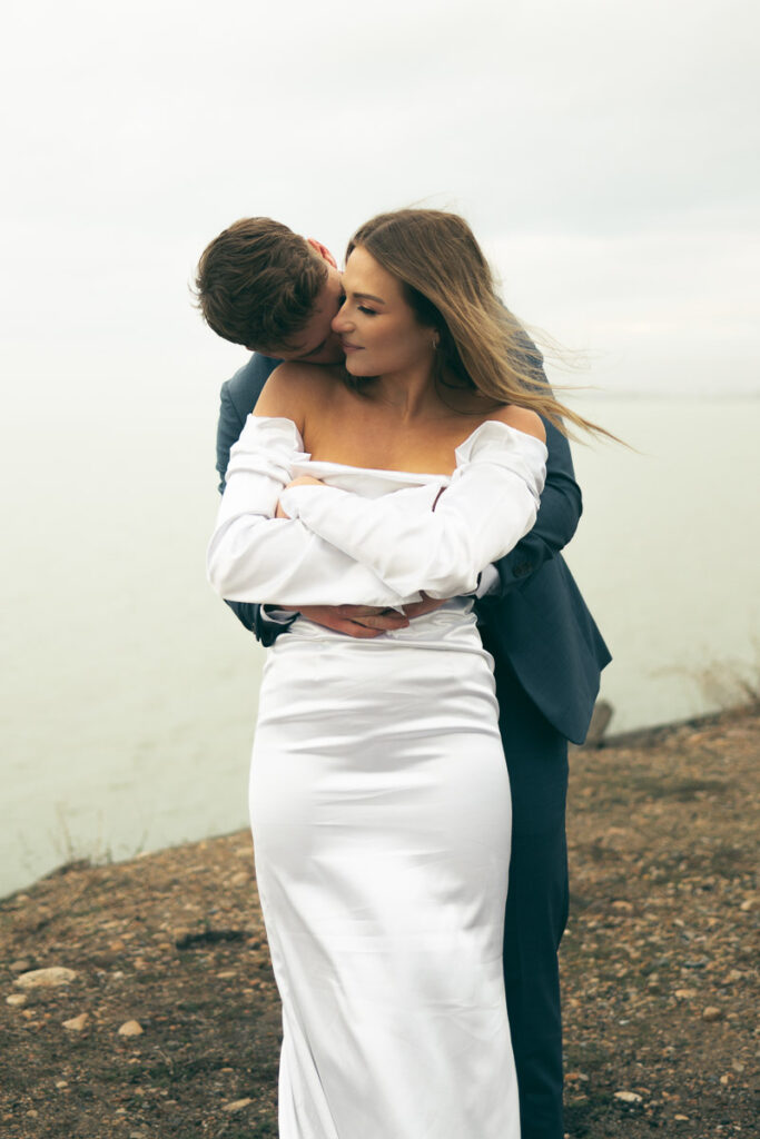 bride and groom snuggling up on wedding day