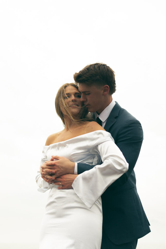 groom whispering "i love you" into his bride's ear