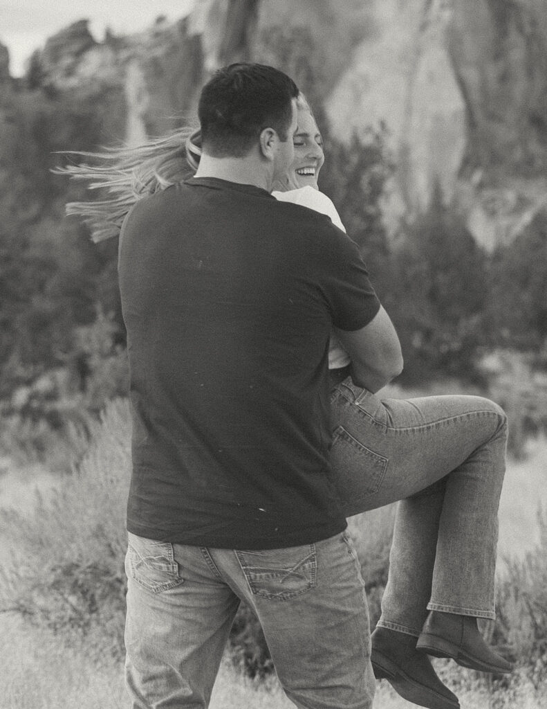 engaged couple having fun at smith rock state park