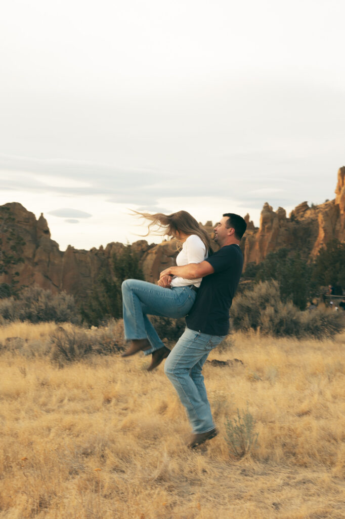 motion blur photo of engaged couple swinging around