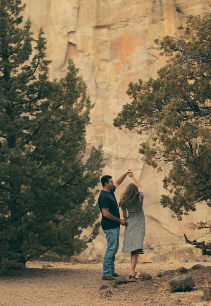 groom spinning his bride around at smith rock state park