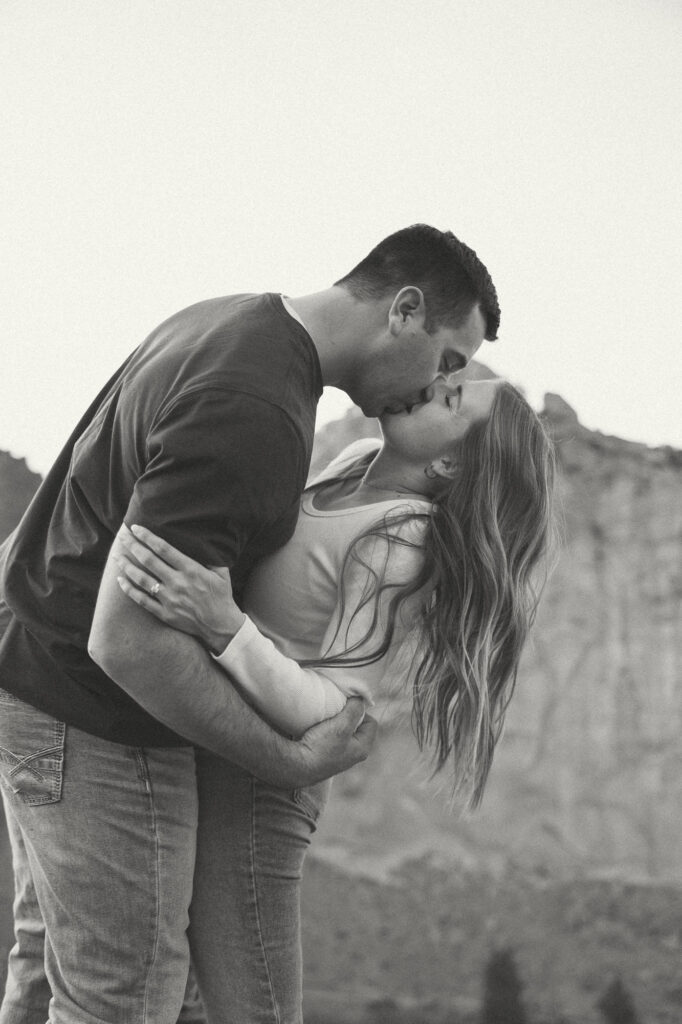 engaged couple kissing at smith rock state park