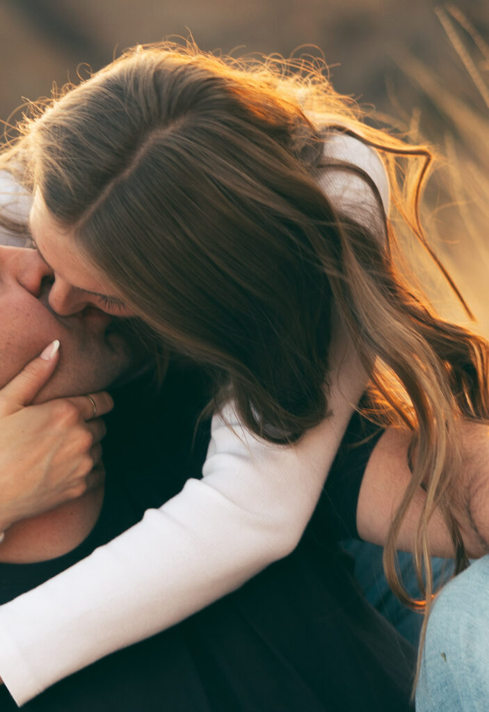 bride and groom kissing while sitting in bend oregon