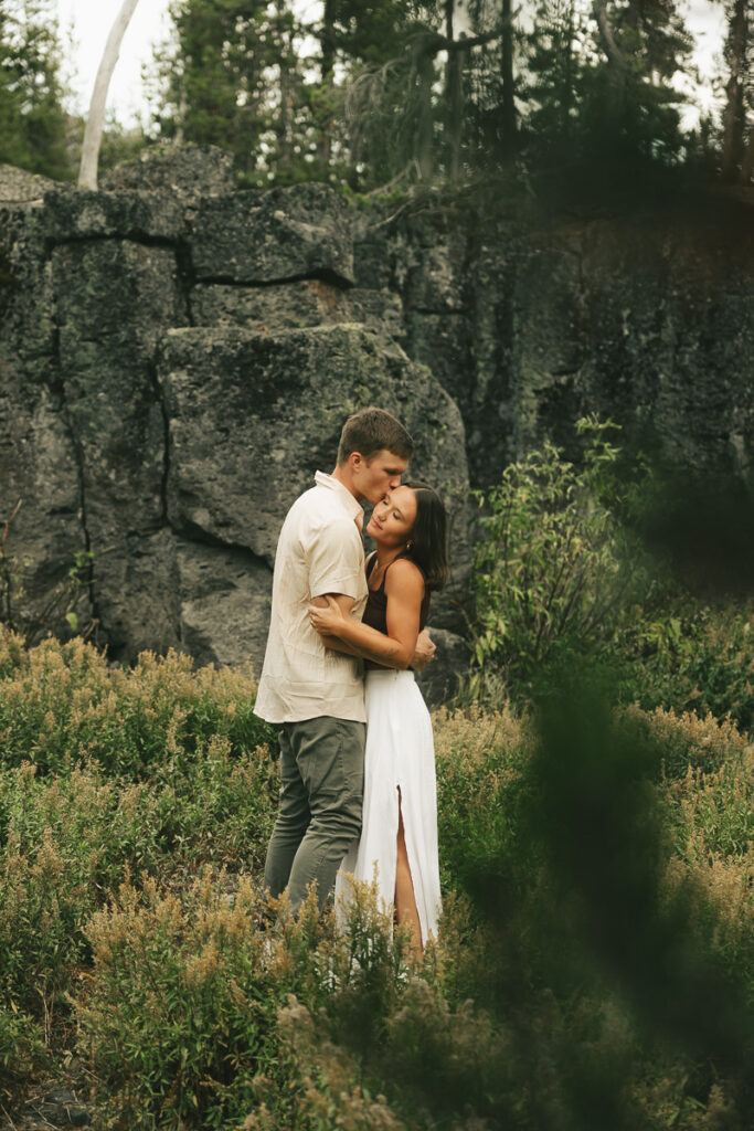 future bride and groom dancing in field