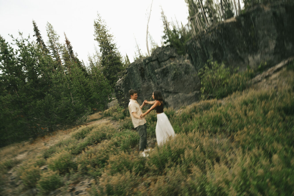 couple spinning around in field