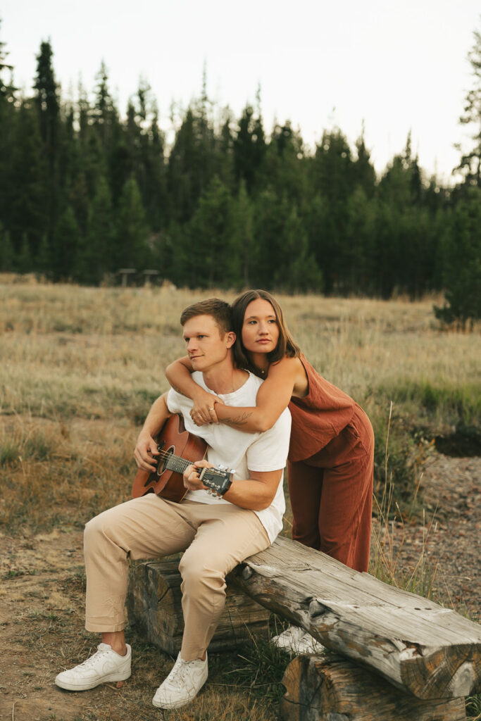 couple playing guitar together at engagement session