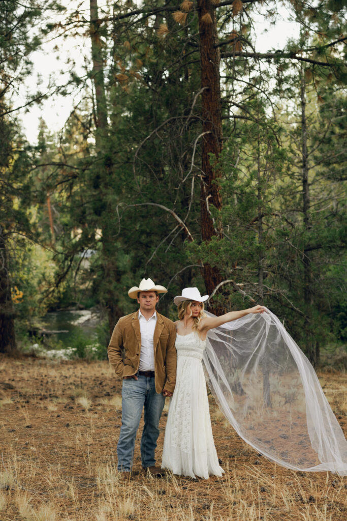 bride and groom photo with veil blowing in wind