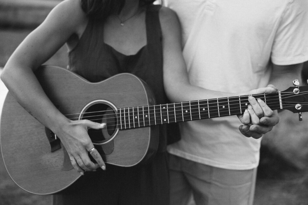 detail photo of guitar and hands