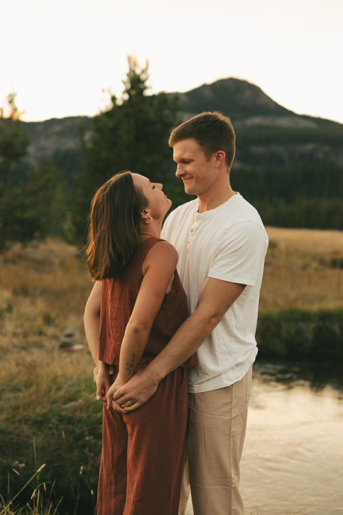 couple admiring each other as the sun sets during their engagement session