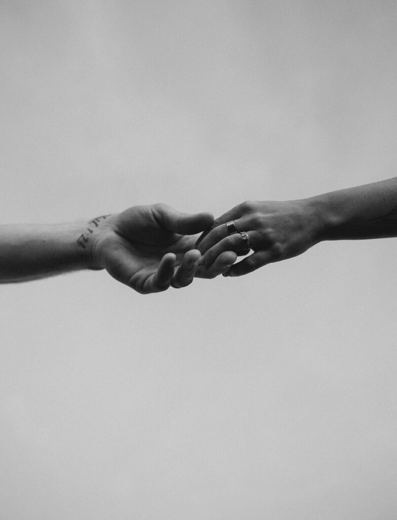 detail photo of couple holding hands at bend engagement photo session