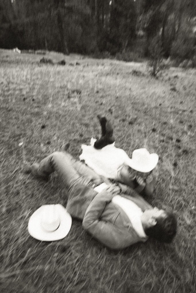 bride and groom laying on ground chatting about their wedding