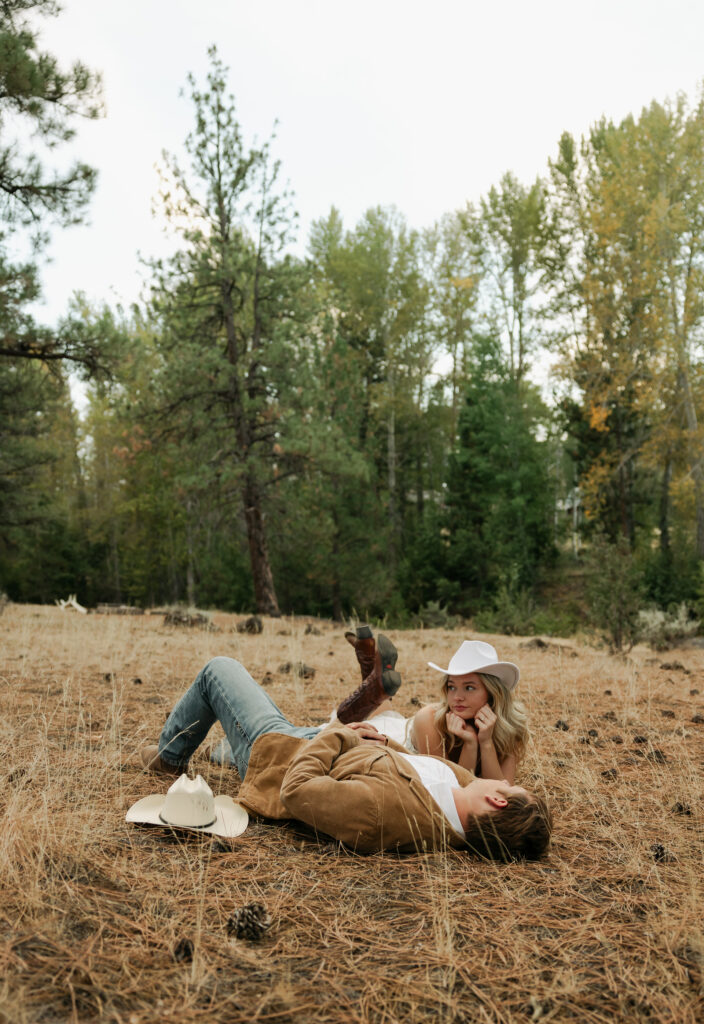 bride and groom rolling around enjoying each other 