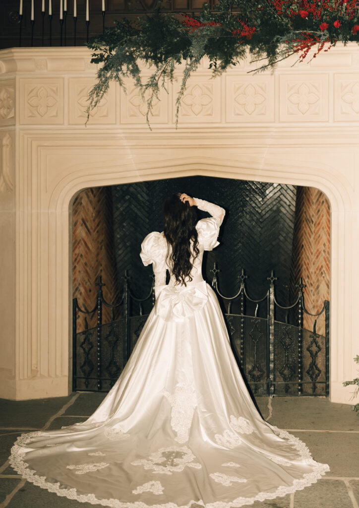 bride facing mantle, showing off back of dress