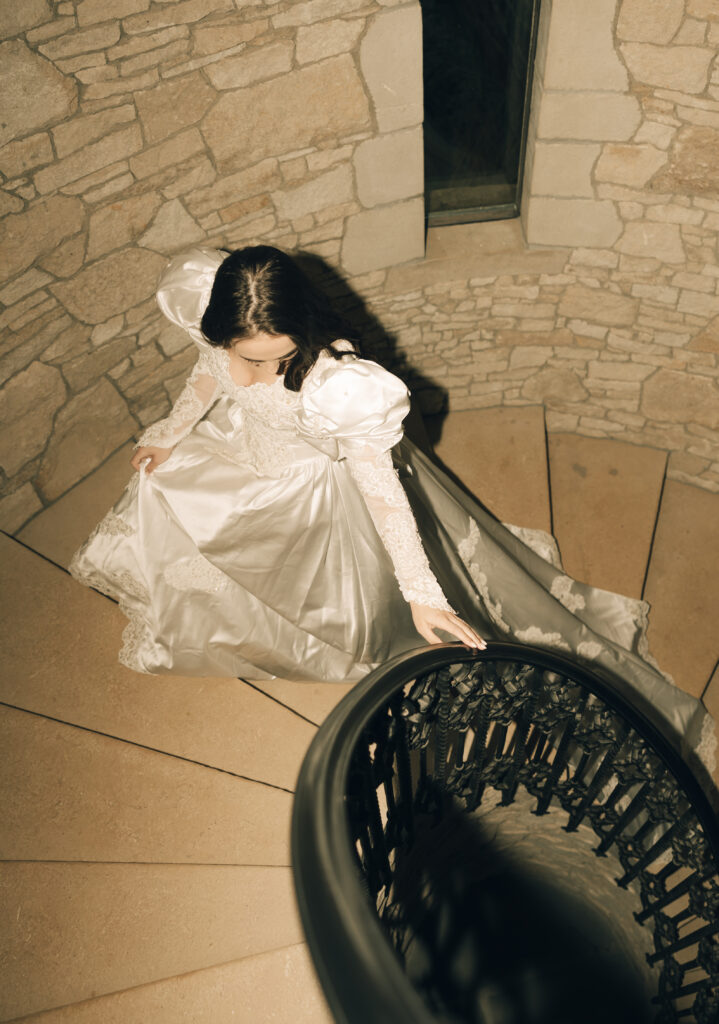 bride walking up spiral staircase