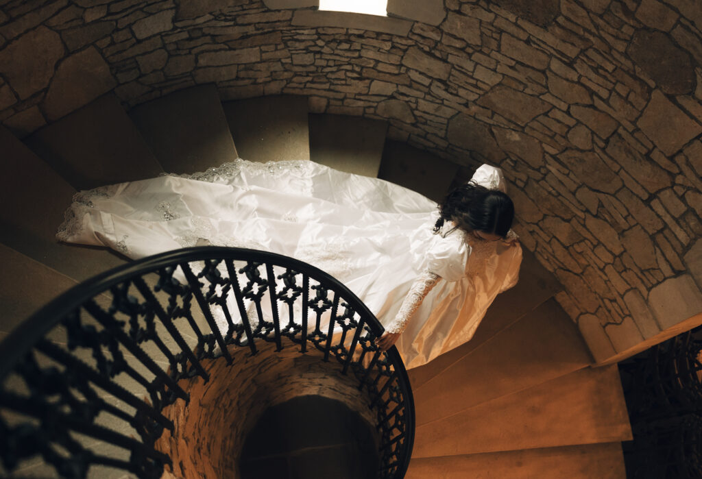 bride walking down spiral staircase