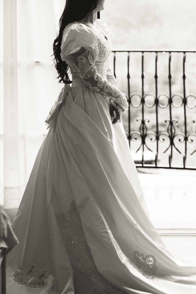 bride posing for detail shot of her vintage dress