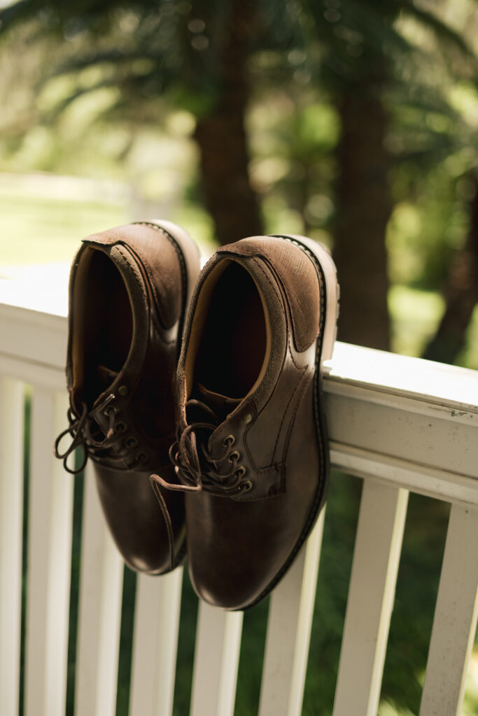 groom's shoes handing on railing