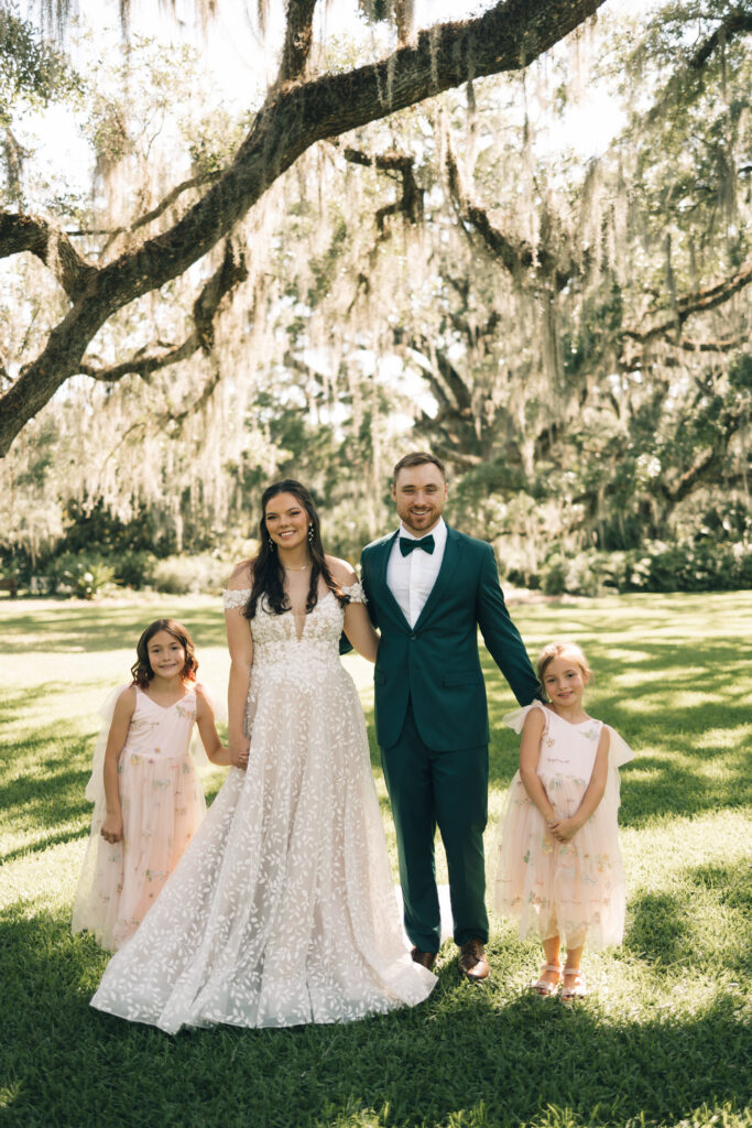 bride and groom with flower girls