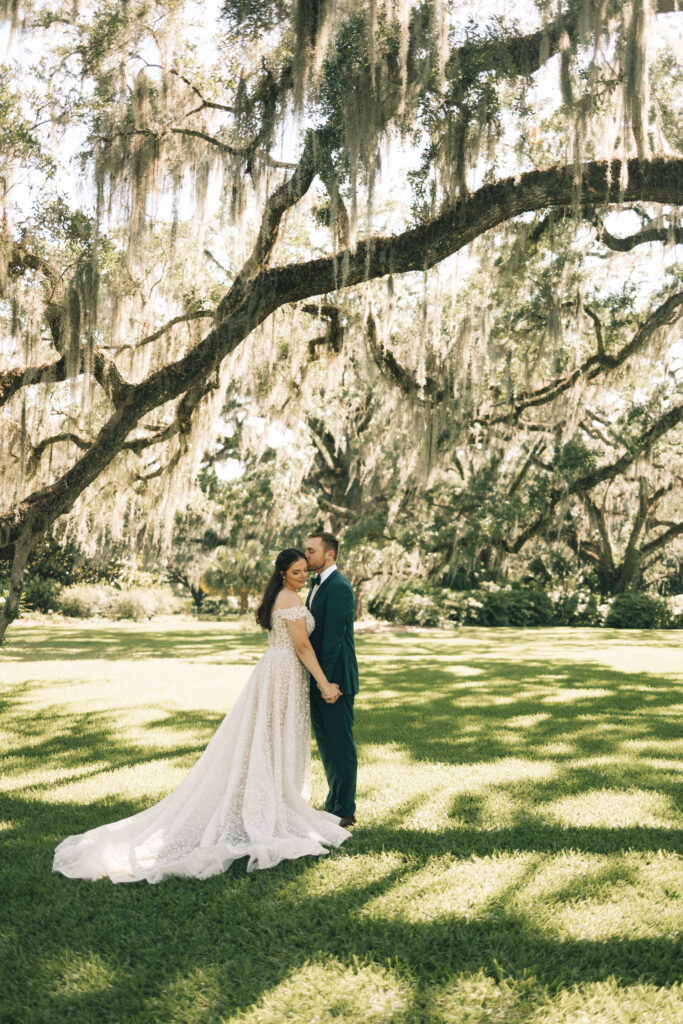 bride and groom facing eachother and groom kissing bride's temple