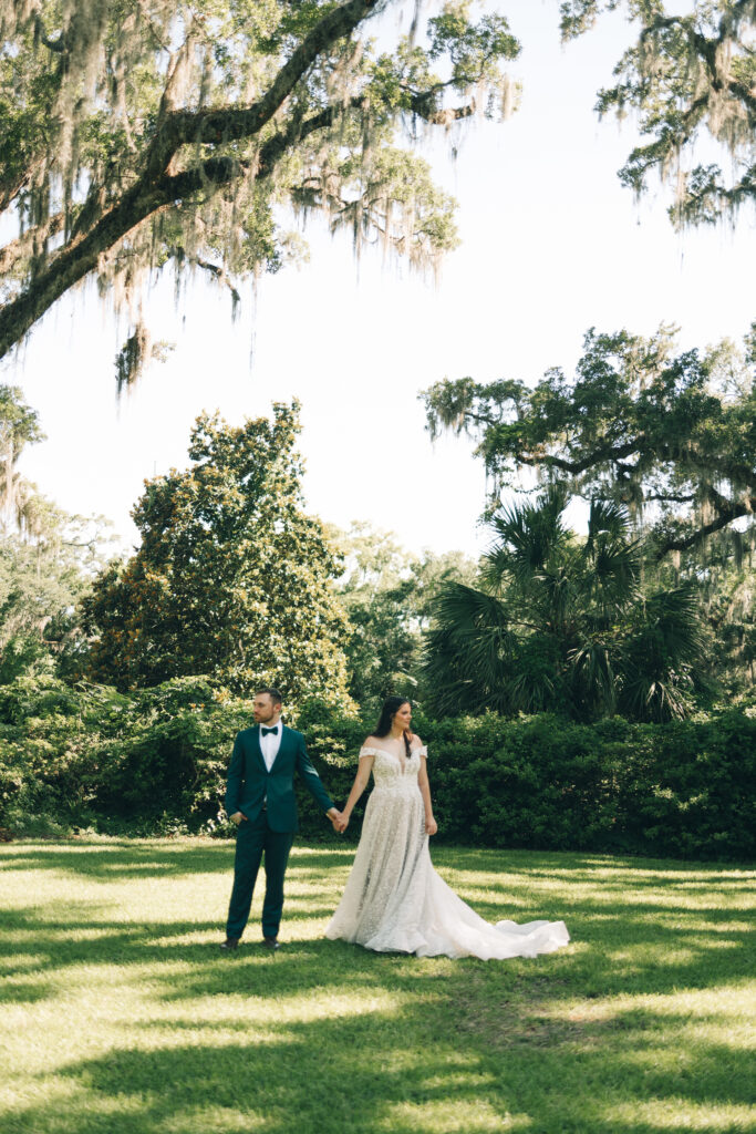 bride and groom holding hands and looking out in editorial wedding photo