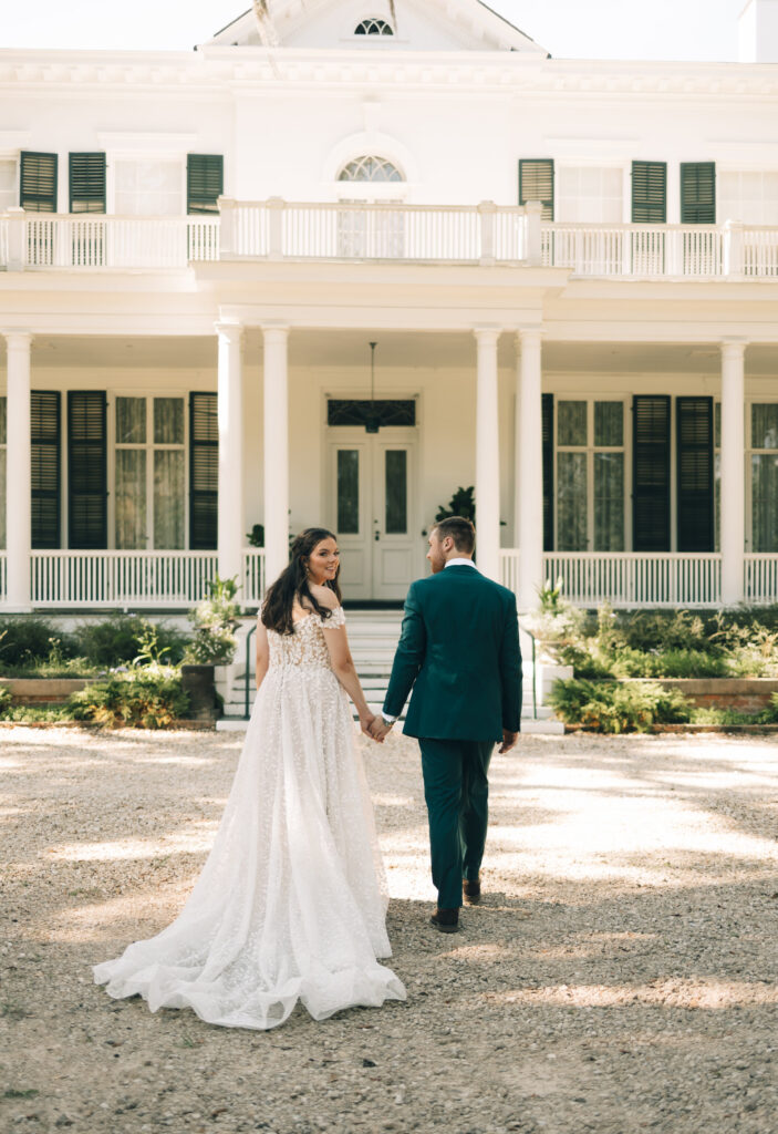 bride and groom walking up to Goodwood Museum & Garden