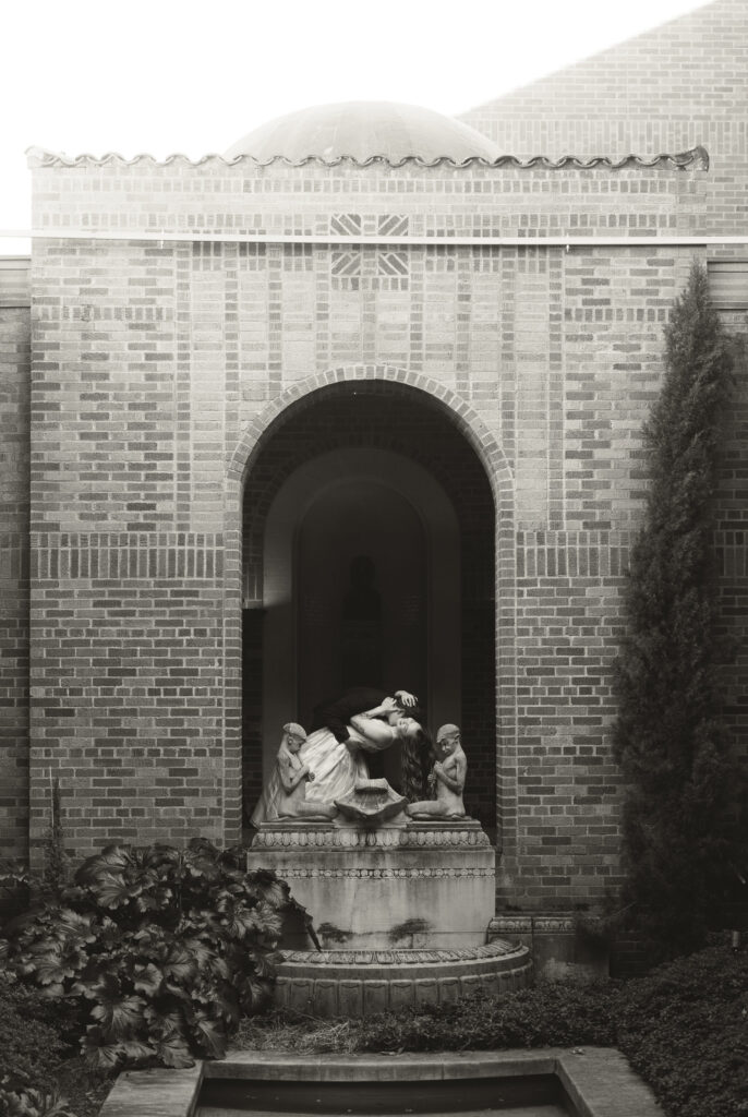 groom is dipping bride and kissing her neck