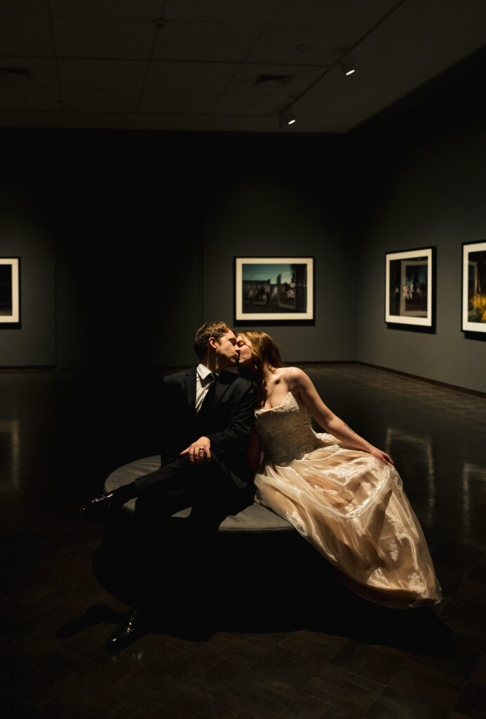 bride and groom sharing a kiss in museum