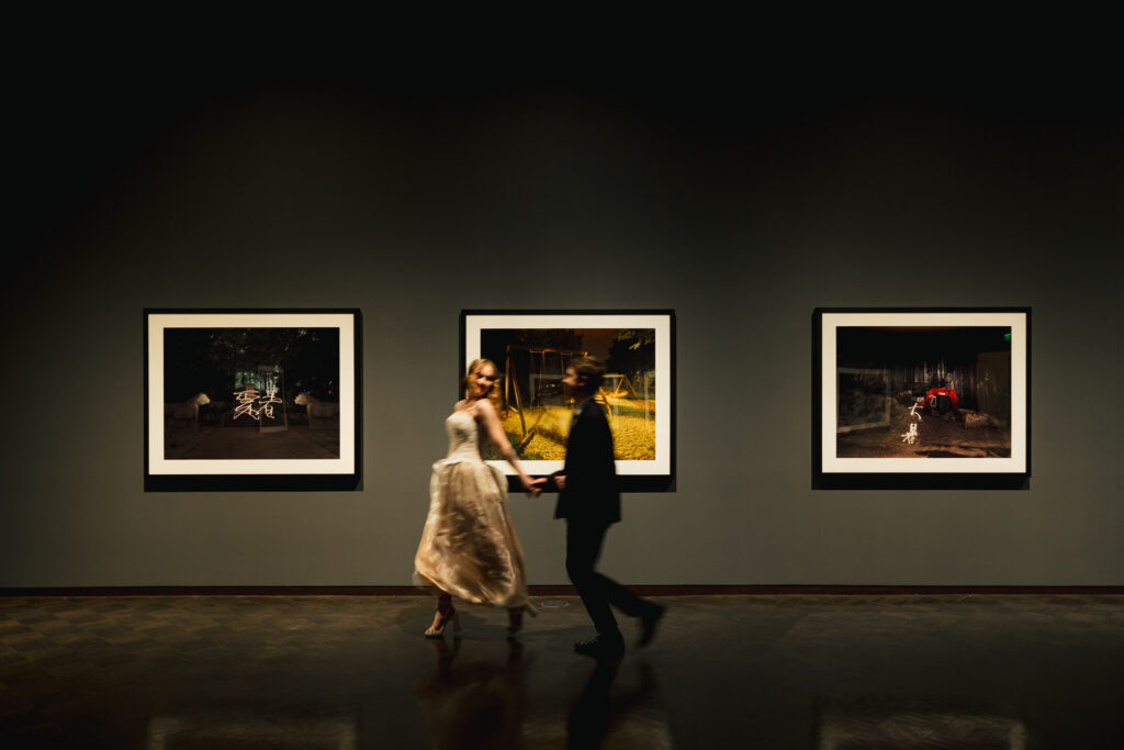 wedding couple running through museum