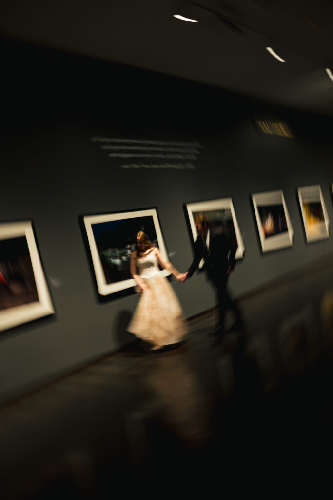 wedding couple running through museum. motion blur