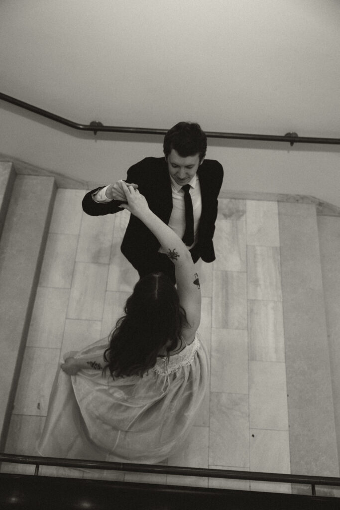 wedding couple spinning on regal stairs