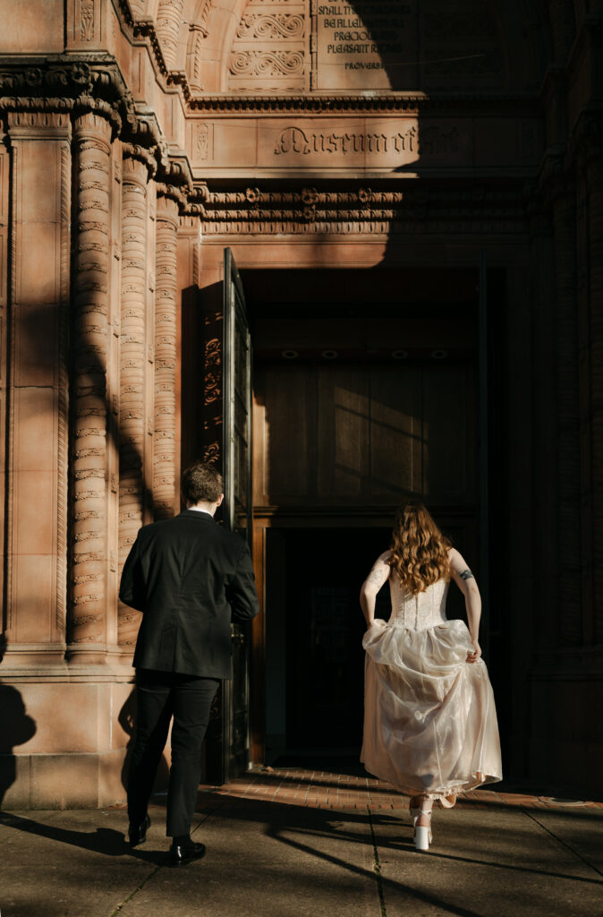 wedding couple walking into historic wedding venue