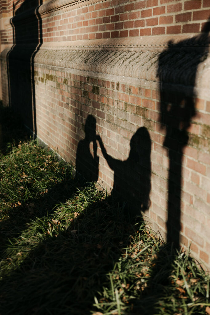 shadow of groom kissing bride's hand