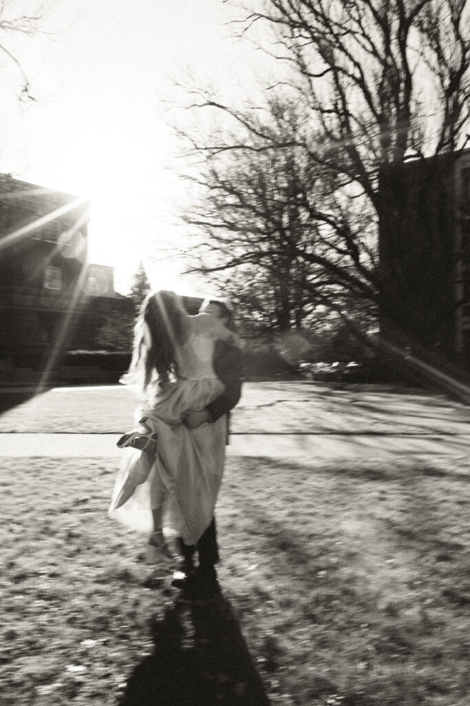 groom picking up bride in courtyard. motion blur