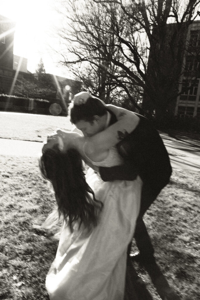 groom dipping and kissing bride's neck