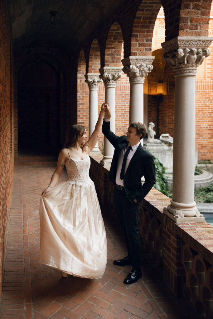 groom spinning bride in museum