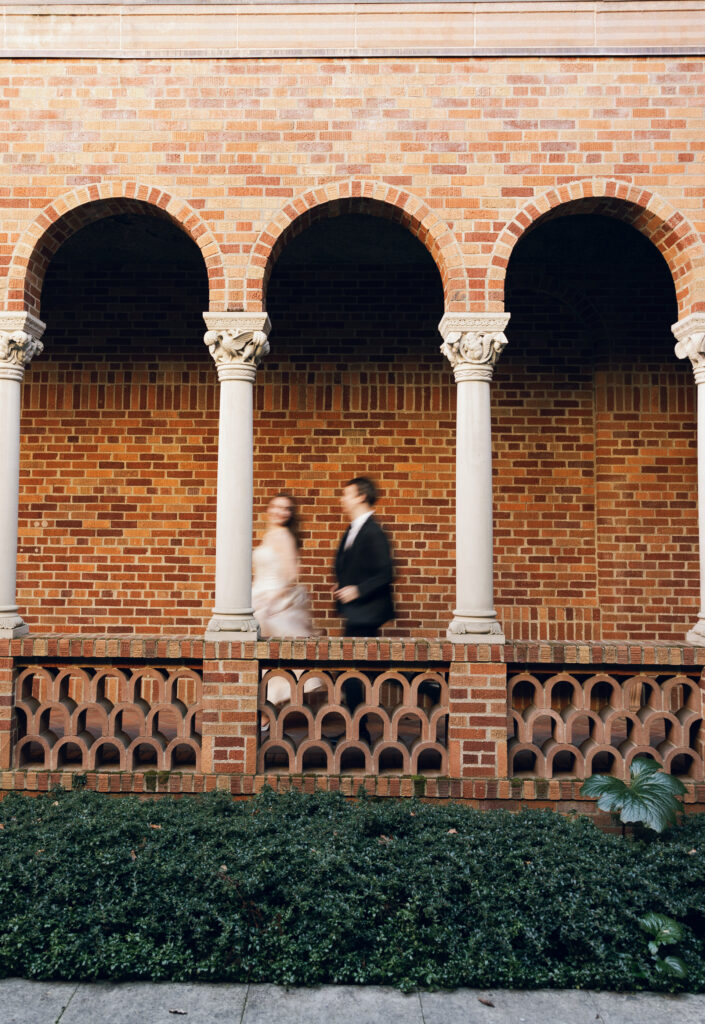 motion blur photo of wedding couple running in museum