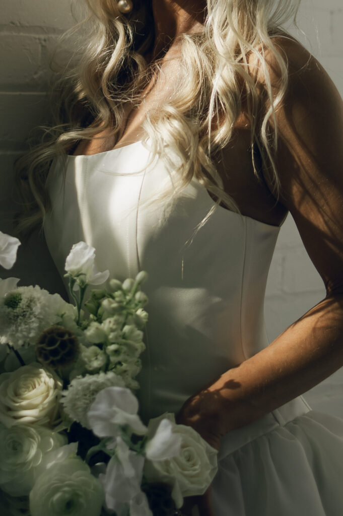 close up of bride's dress and bouquet