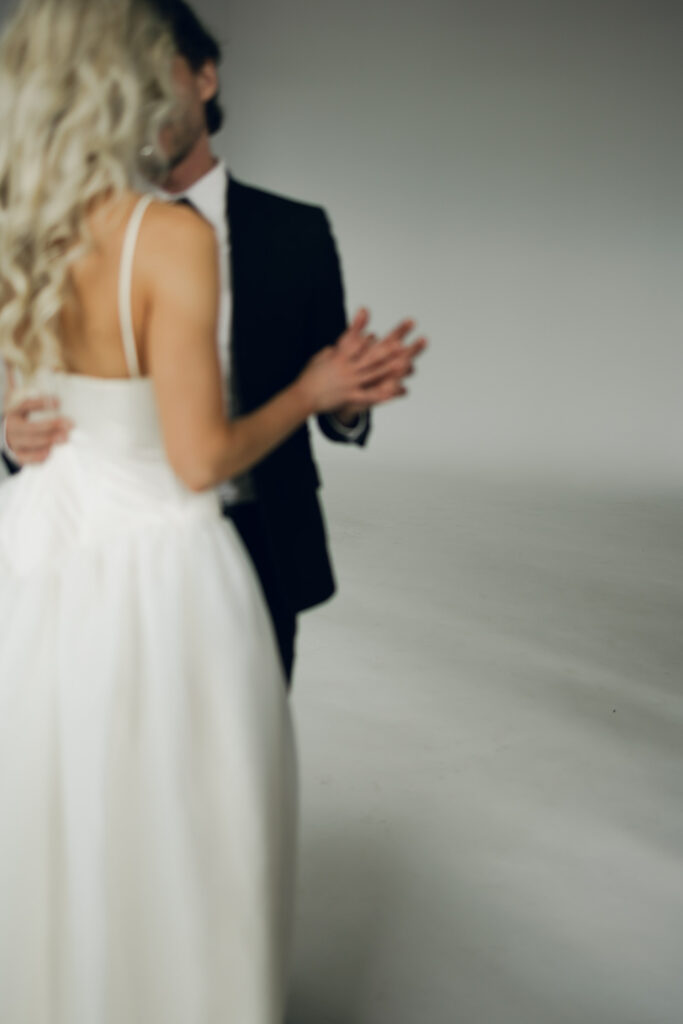 blurred image of bride and groom's hands