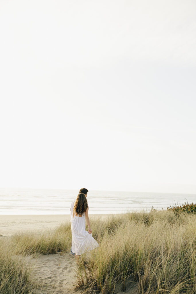 engaged couple at beach during engagement photos