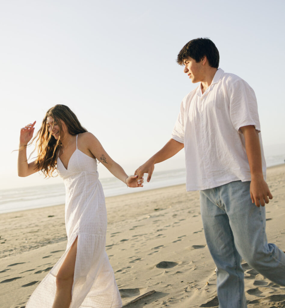 documentary photos of couple walking on beach