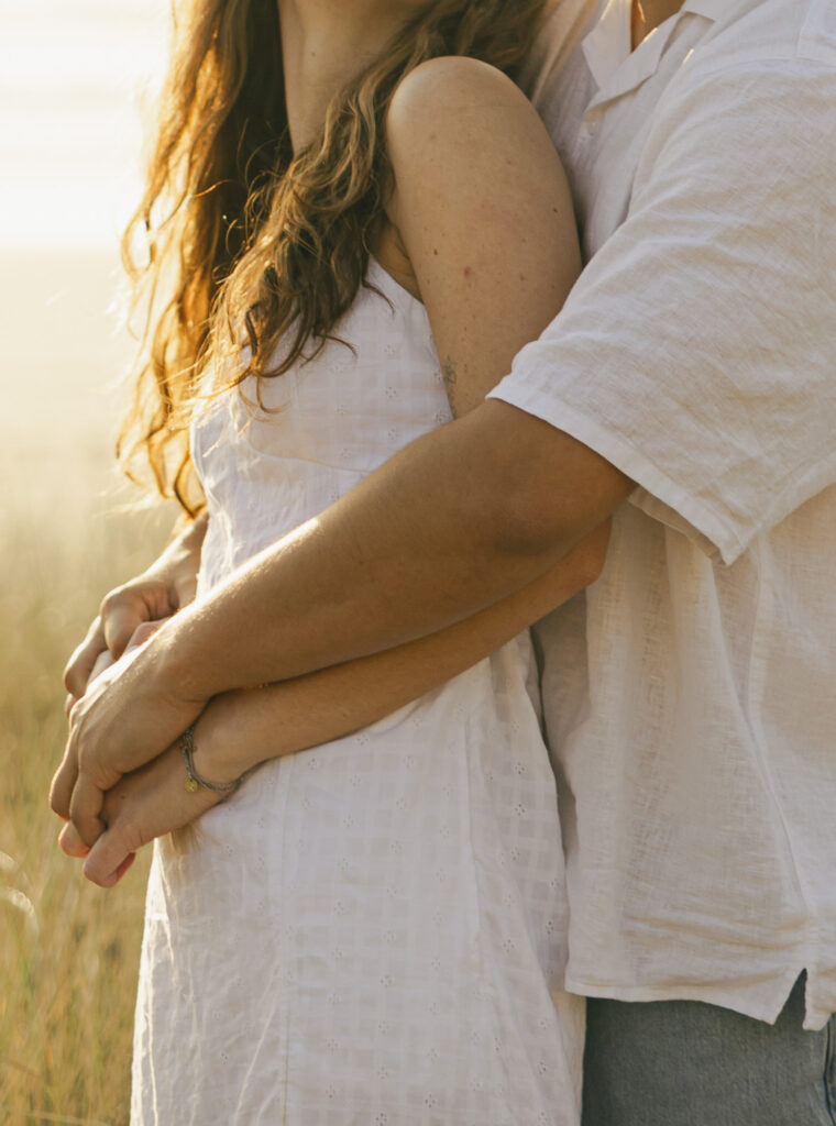 close up of guy holding girl from behind