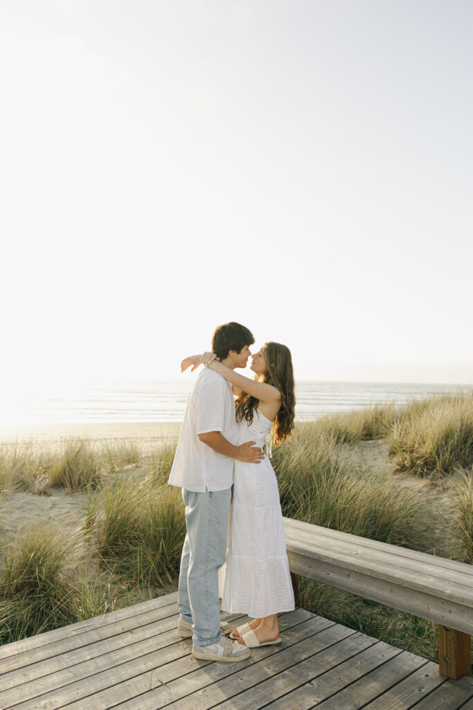engaged couple embracing at beach