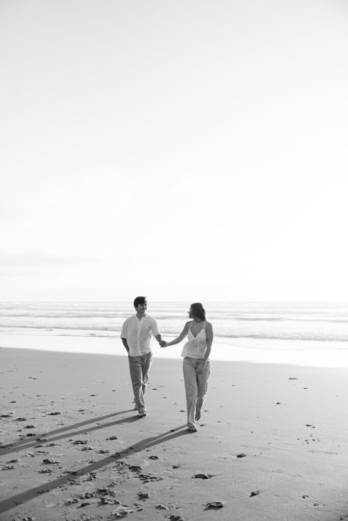 couple walking towards camera at beach