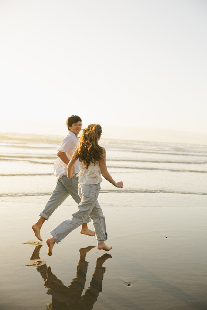 photos of couple running at beach