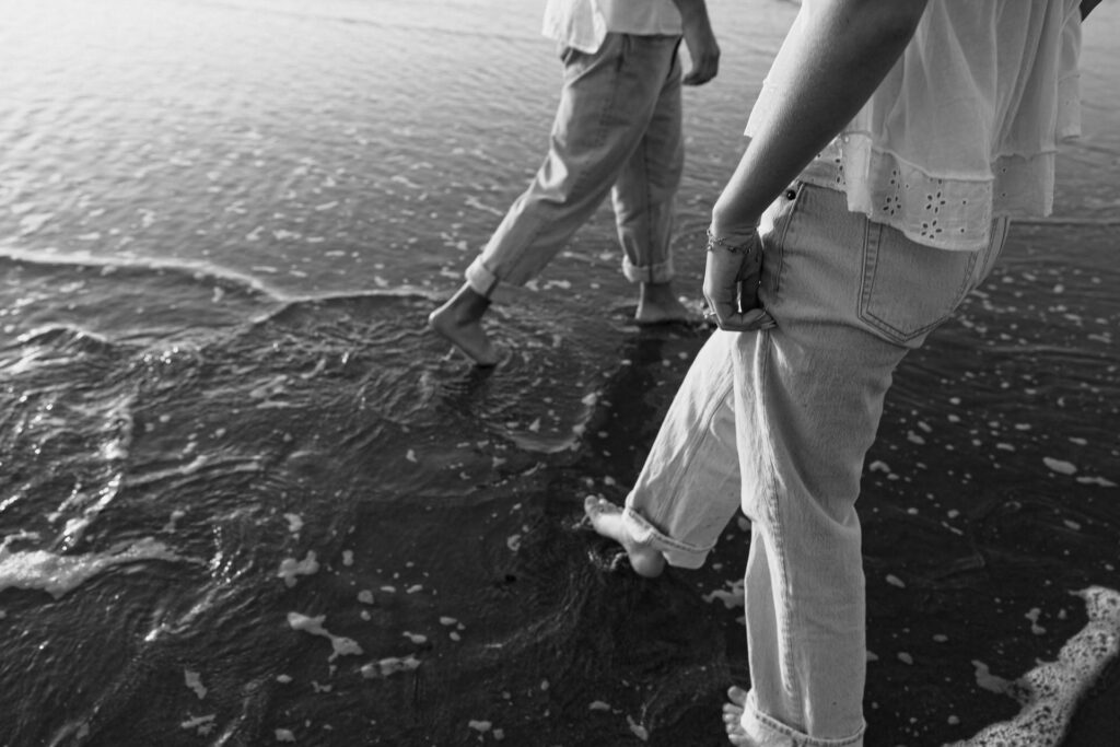 black and white photo of couples legs and feet