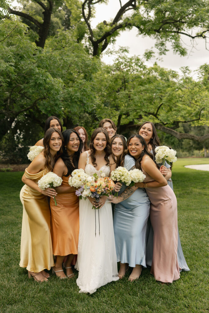 bride and bridesmaids smiling at camera